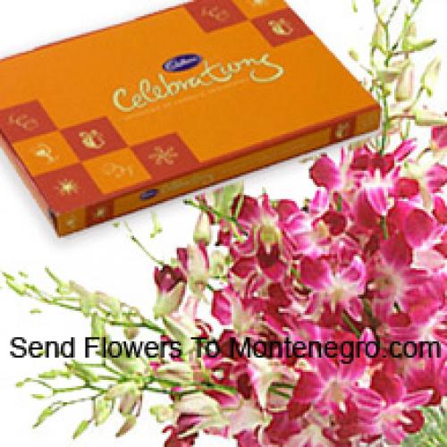 Boeket roze orchideeën met assortiment chocolaatjes