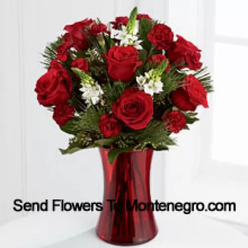 This romantic arrangement bristles with the passion and wonder of the Christmas season. Rich red roses and burgundy mini carnations accented with the snowy white blooms of Stars of Bethlehem, pine branches, and lush greens will easily sweep them off their feet. Arranged in a ruby red clear glass vase, this bouquet conveys your most heartfelt holiday wishes. (Please Note That We Reserve The Right To Substitute Any Product With A Suitable Product Of Equal Value In Case Of Non-Availability Of A Certain Product)